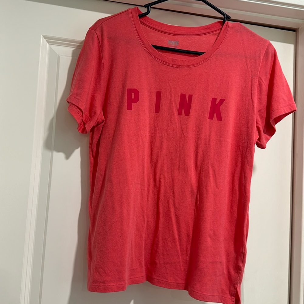 Women’s size large coral in color t-shirt.